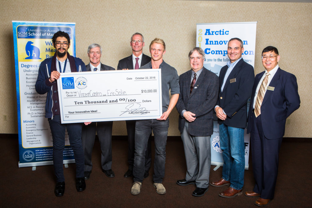 Vincent Castro, UAF Chancellor Dana Thomas, UA President Jim Johnsen, Eric Solie, School of Management Dean Mark Herrmann, Frank Paskvan of BP and Professor Ping Lan pose with the grand prize check at the 2016 Arctic Innovation Competition.