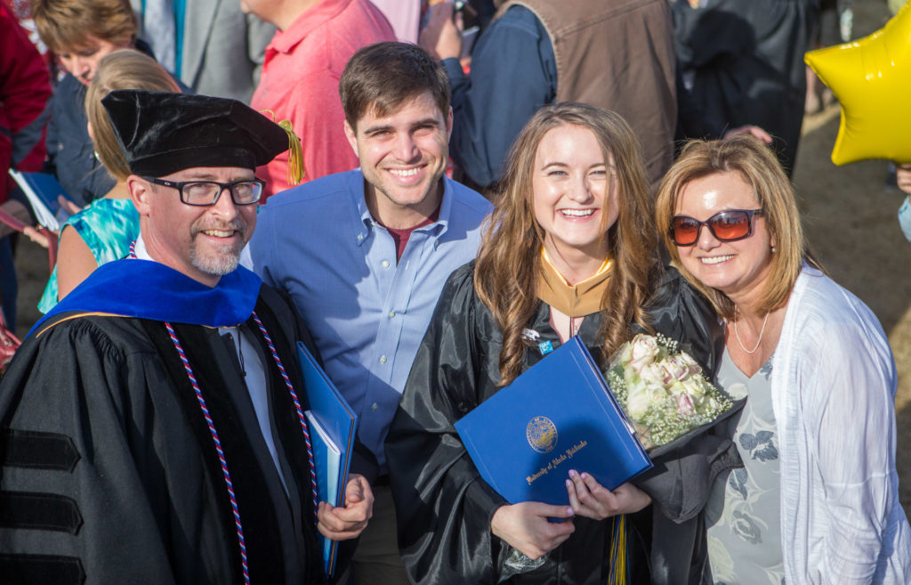 Cam with his daughter Shelby, her boyfriend Tom, and his wife Debbie at Commencement 2017. Photo by Troy Bouffard.. 
