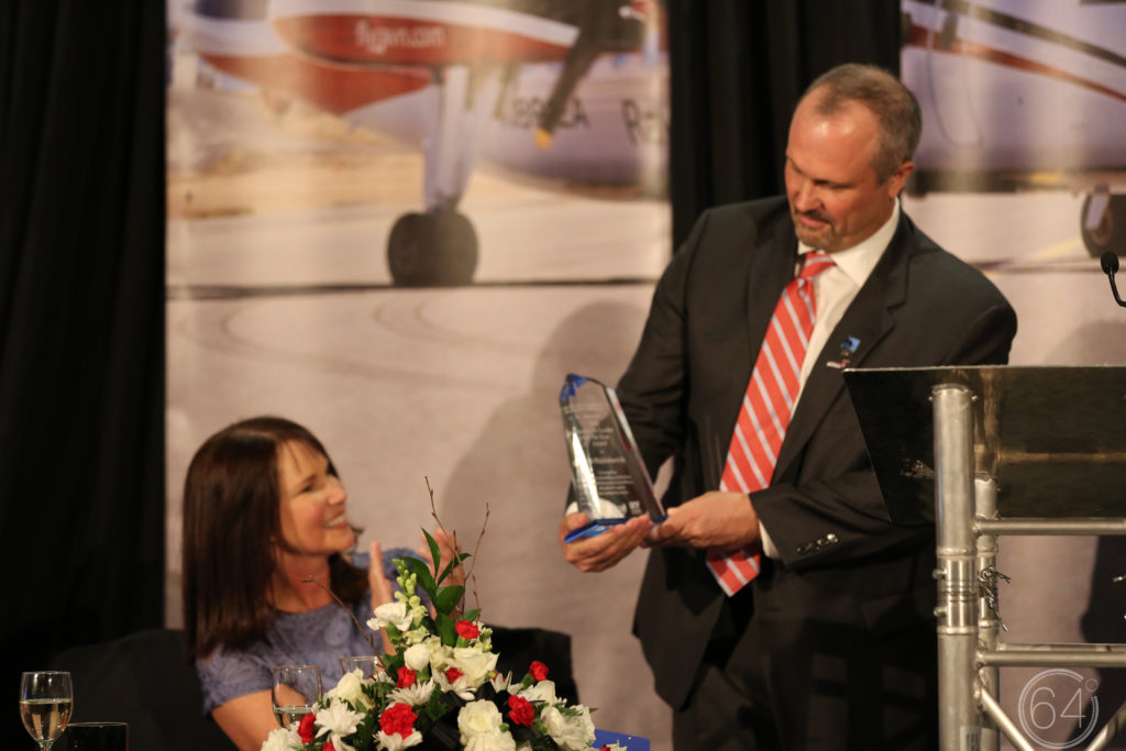 Bob's wife, Leslie, looks on as he accepts the award