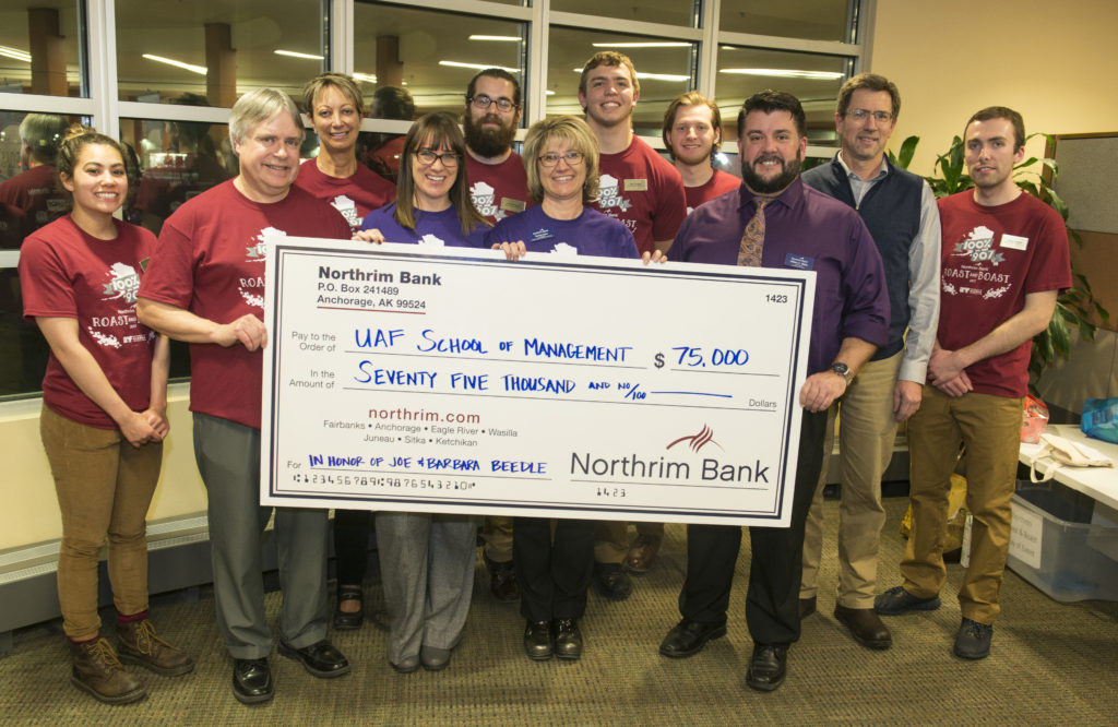 School of Management students and staff and executives from Northrim bank pose with the generous donation from Northrim Bank and Joe and Barbra Beedle. Photo by Greg Martin.