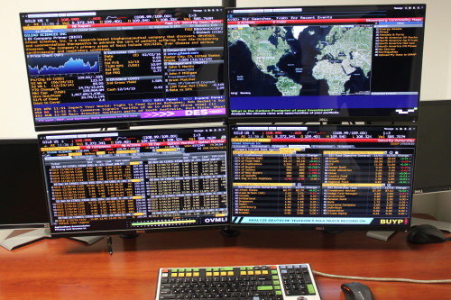 Image showing 4 monitors with Bloomberg stocks