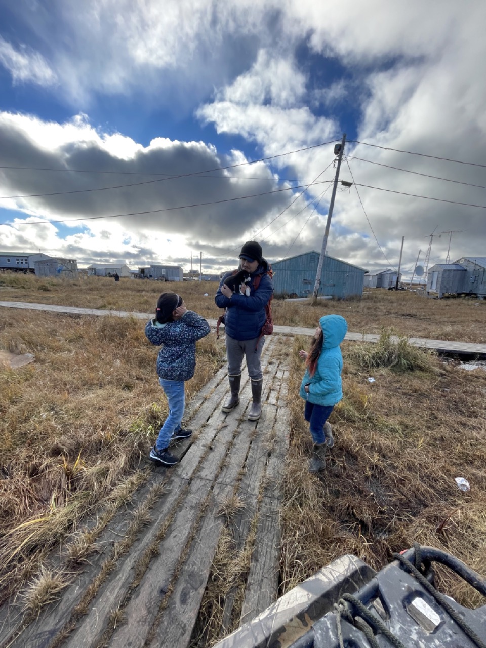 Picasso on a response mission with two children showcasing their Alaska Husky and puppy.