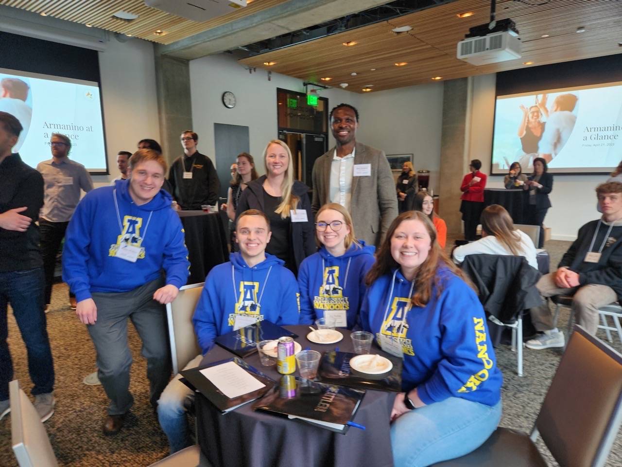 four students sit together at conference