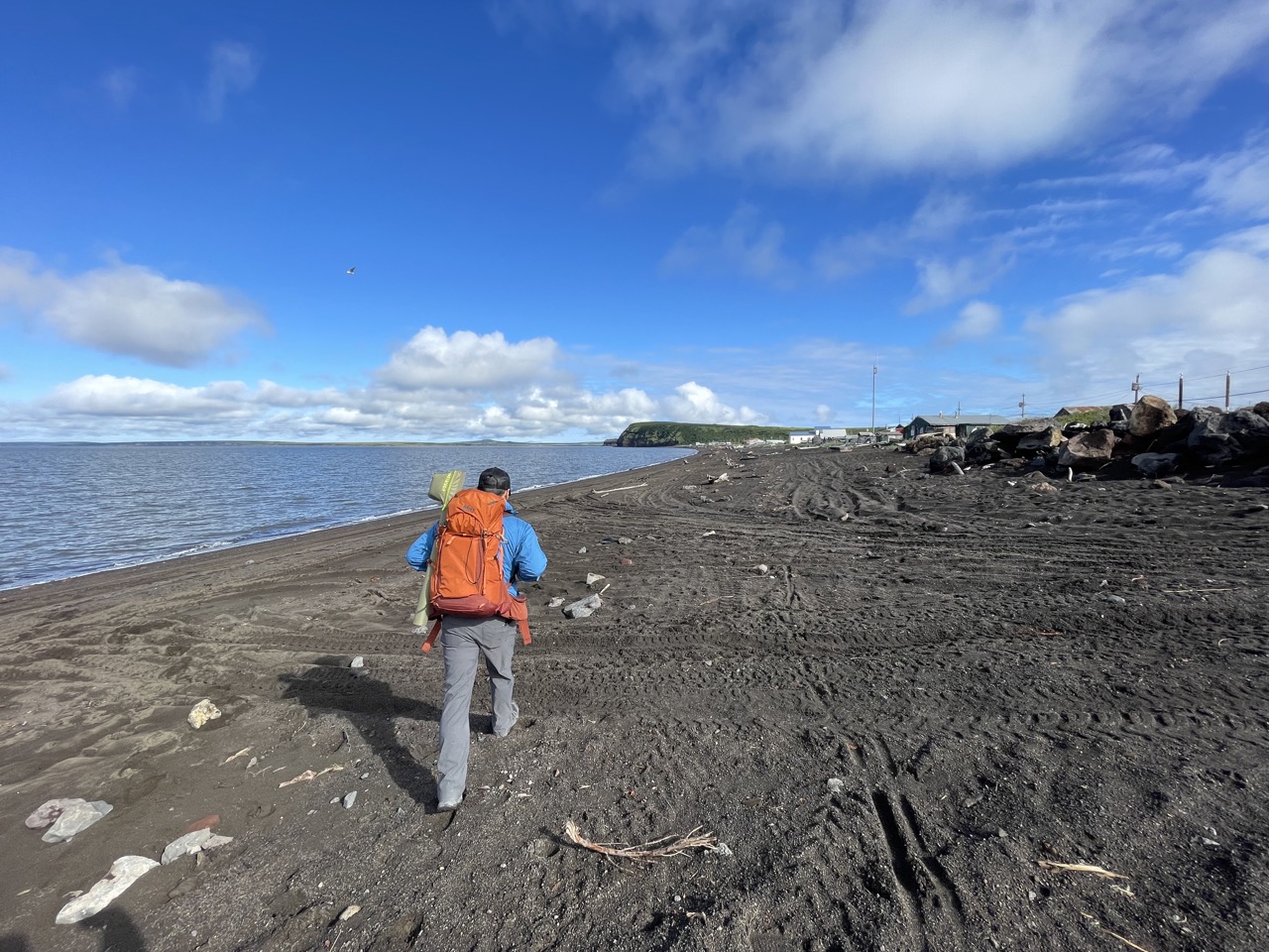 Anthony walking along the shore in Stebbins, Alaska post Typhoon Merbok surveying damage to the coastline, homes and fish camps. 
