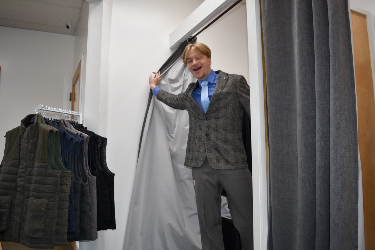  CBSM student Sammy Bass pops out of the fitting room to show off his new suit.