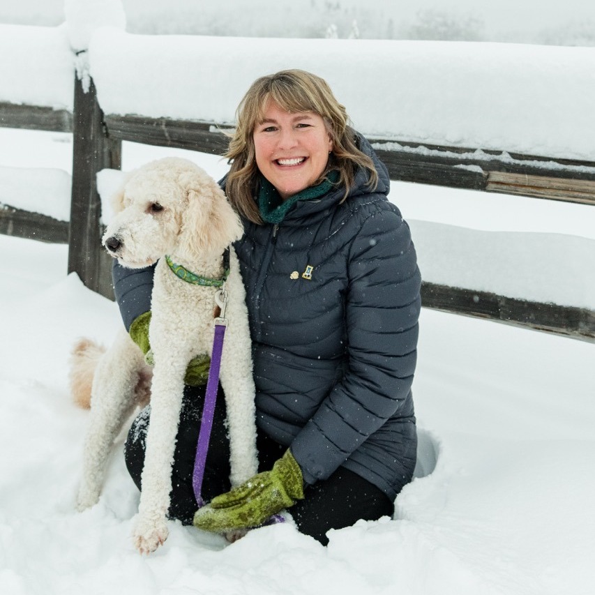 Tracy Vanairsdale stands with dog Copper on a snowy day.