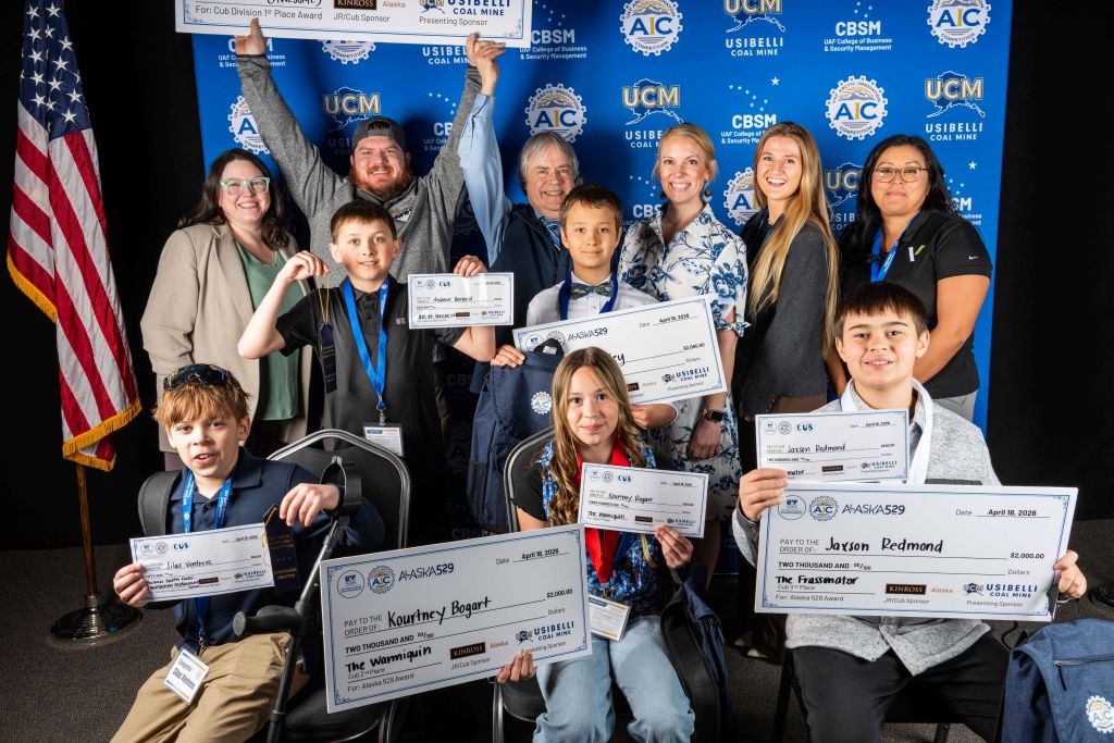 Youth Division competitors at the AIC finals 2026 holding checks with sponsor representatives.