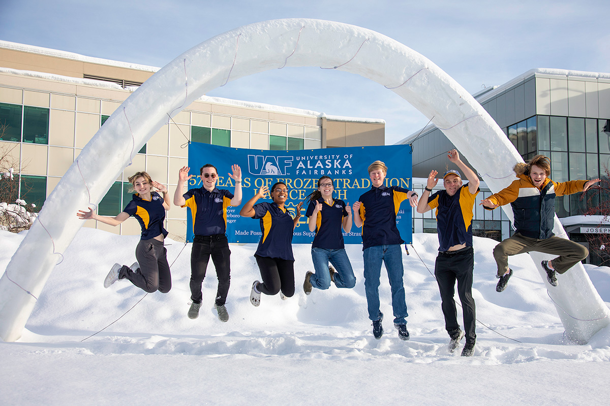 UAF Ice Arch Team jumping in front of ice arch