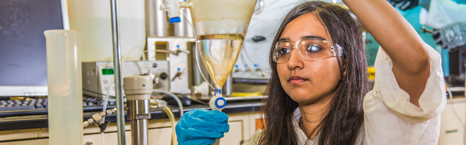 Petroleum engineering graduate students prepares sample in lab