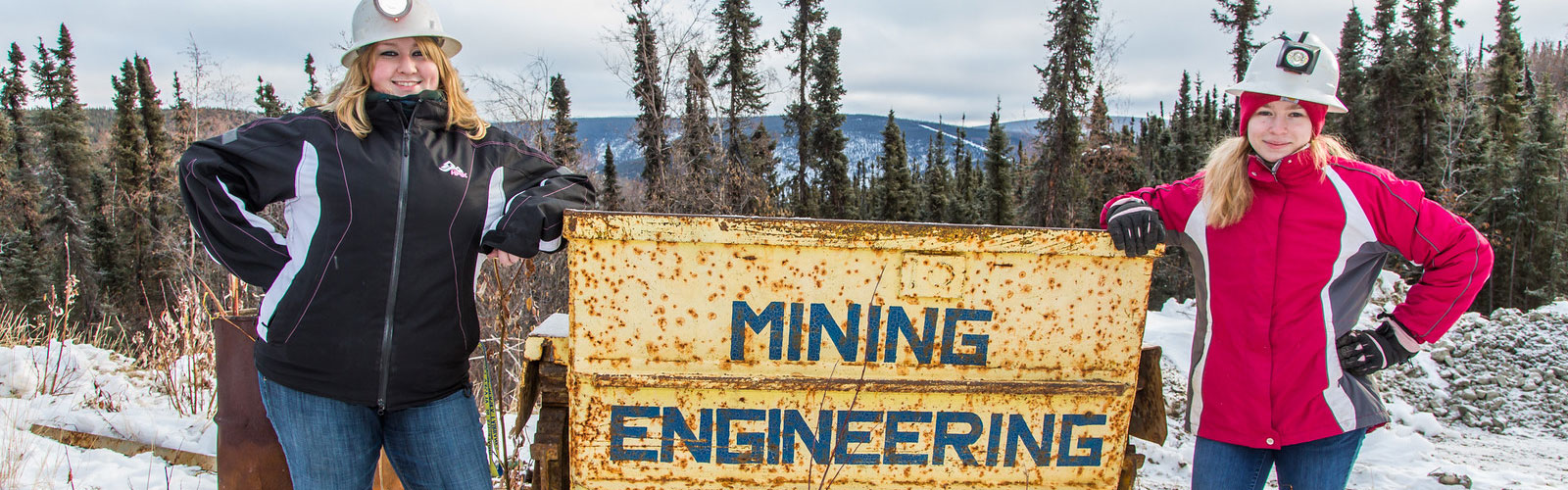 Students posing in front of miningb engineering sign