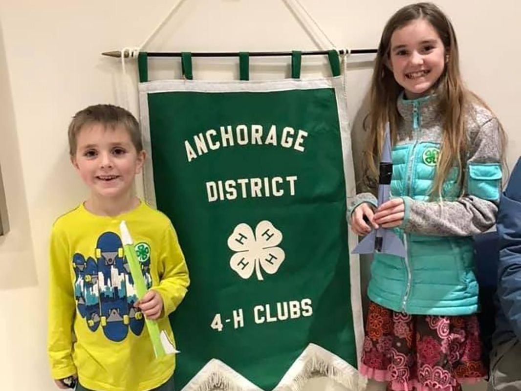 Students beside 4-H anchorage district sign