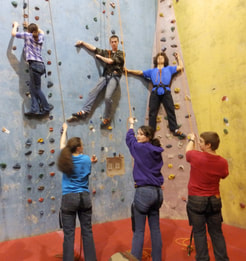 Group of people wall-climbing