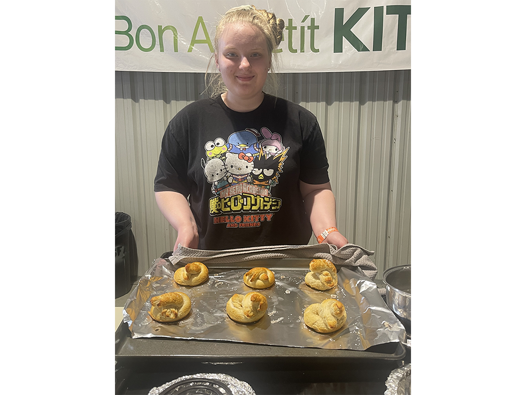 Girl holding a tray of baked pastries