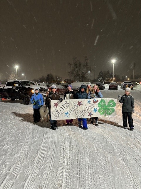 Students holding sign in the snow