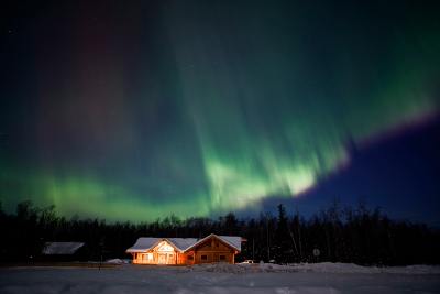 home with snow and the aurora