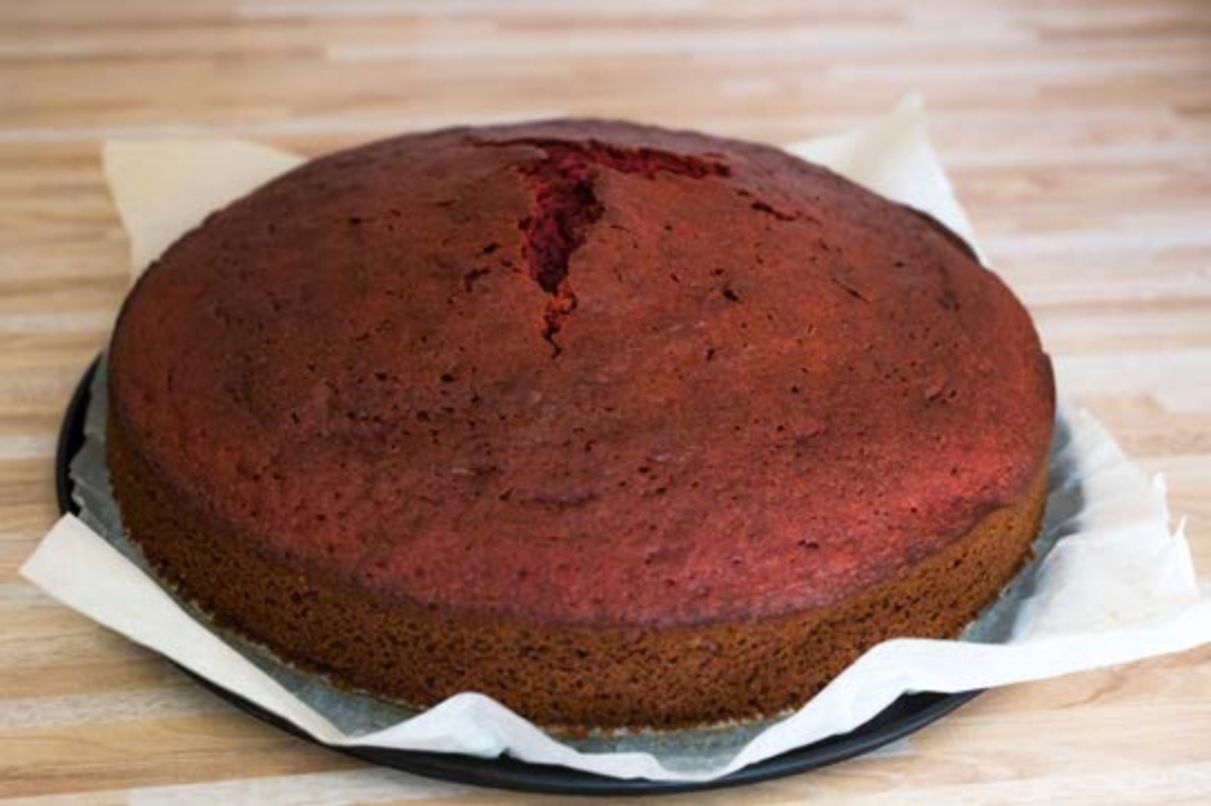 Dark brown cake placed on table to cool