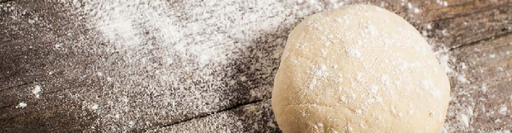 Dough and flour on table