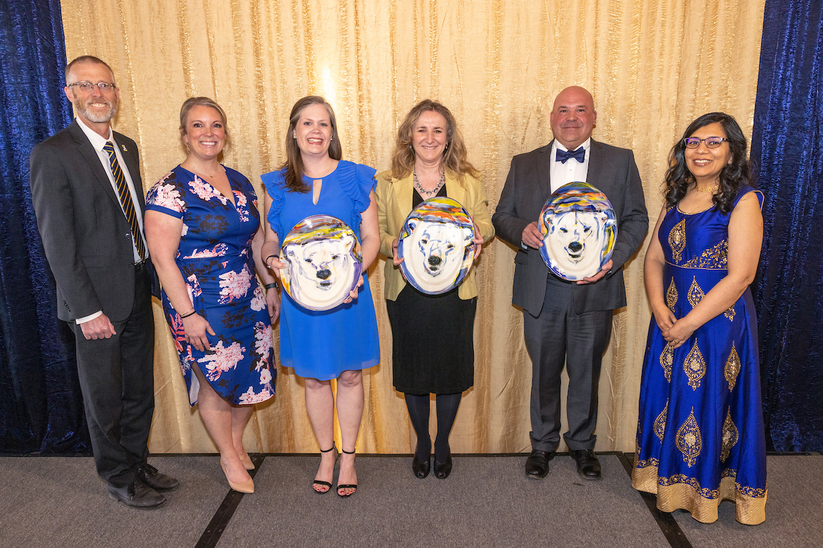 The chancellor and provost pose with award winners at the Blue and Gold celebration