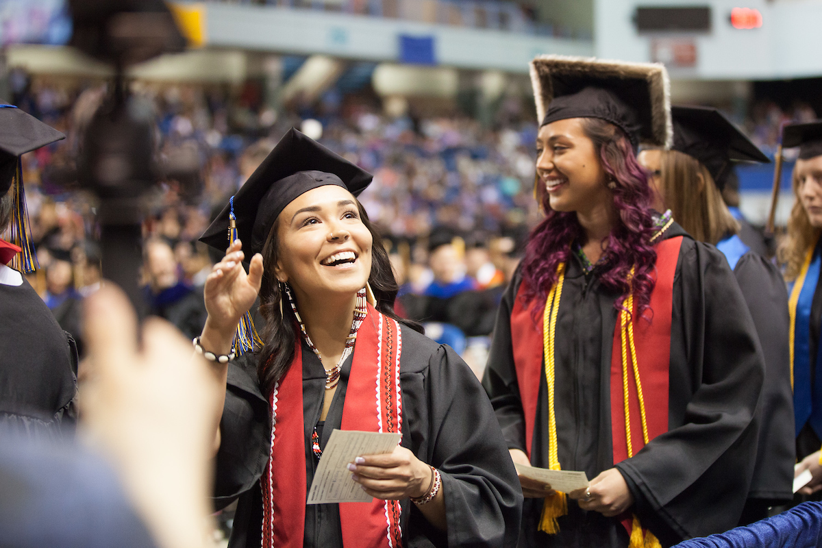 Kelsey Wallace greets people in the audience before walking across the stage during the 2015 UAF commencement ceremony at the Carlson Center. | UAF Photo by JR Ancheta