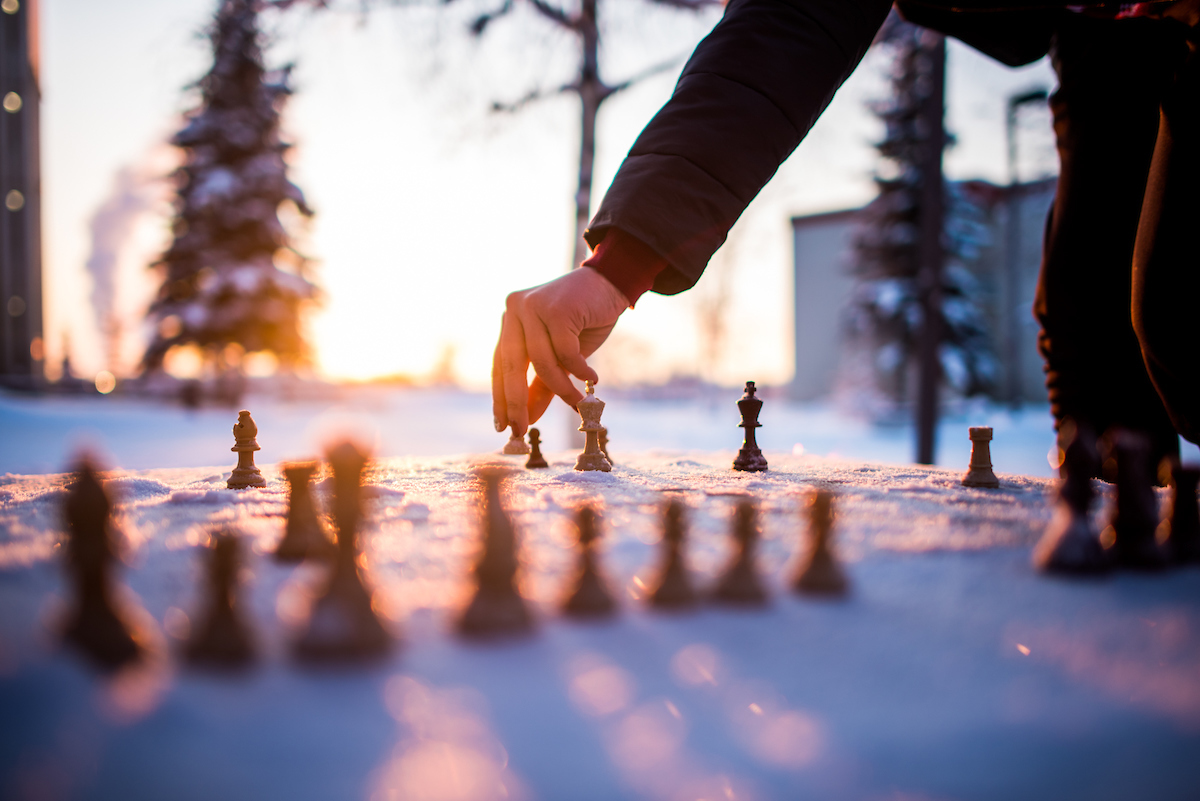 Rachael Teter and Jasmine Jemewouk play chess outside the Greuning building while the temperature hovered near -20F. | UAF Photo by Zayn Roohi