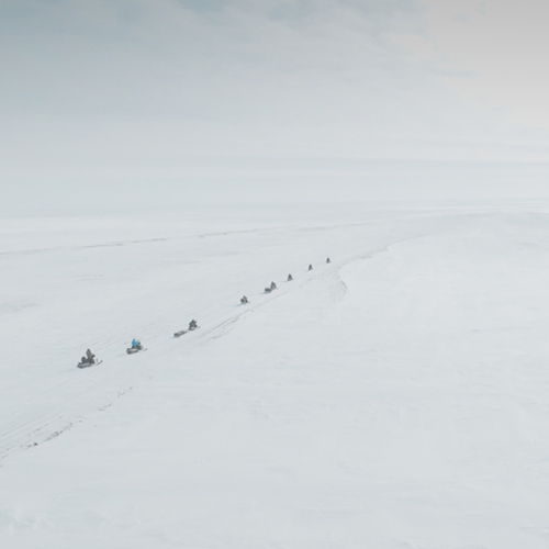 Geophysical Institute Snow and Ice Research. People on snow machines. UAF Photo