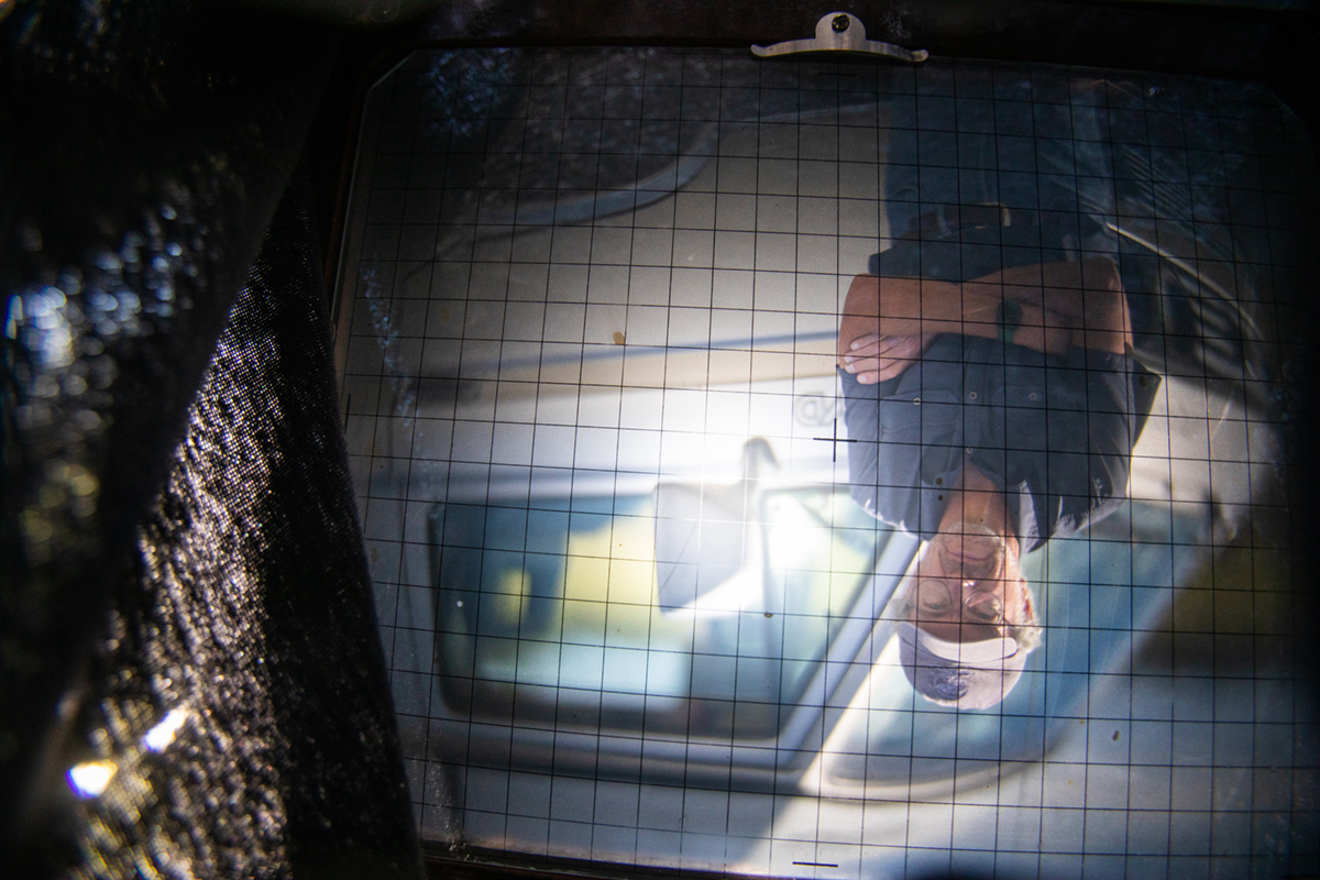 Charles Mason, as viewed through the ground glass of his large format camera. UAF Photo by Eric Engman.