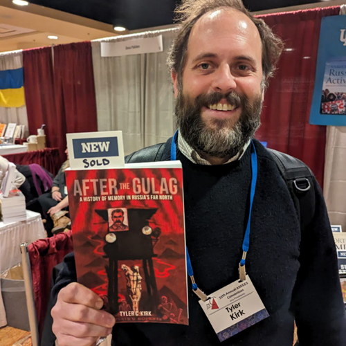 Tyler Kirk holding his book After the Gulag: A History of Memory in Russia's Far North