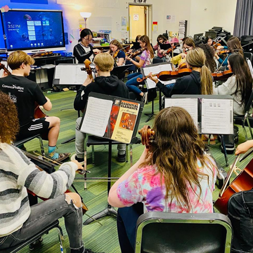 Dr. Sun leads the string orchestra at Ryan Middle School as part of UAF Department of Music's regular outreach program. UAF Photo