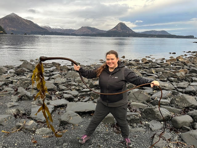 Petra Banks holding bull kelp. Photo courtesy of Megan Koch