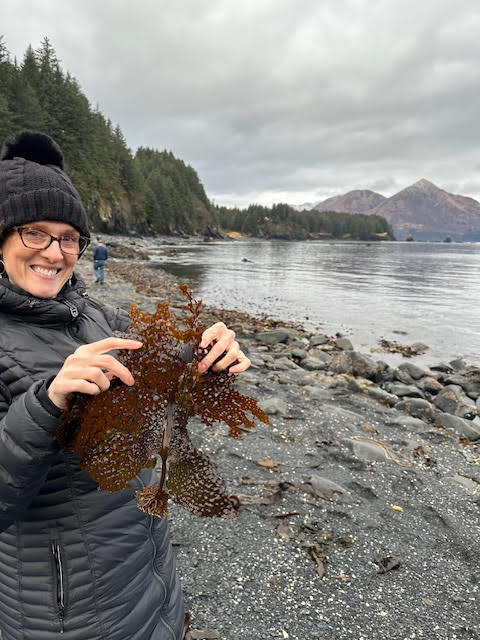 Madara Mason holding brown kelp. Photo courtesy of Megan Koch.