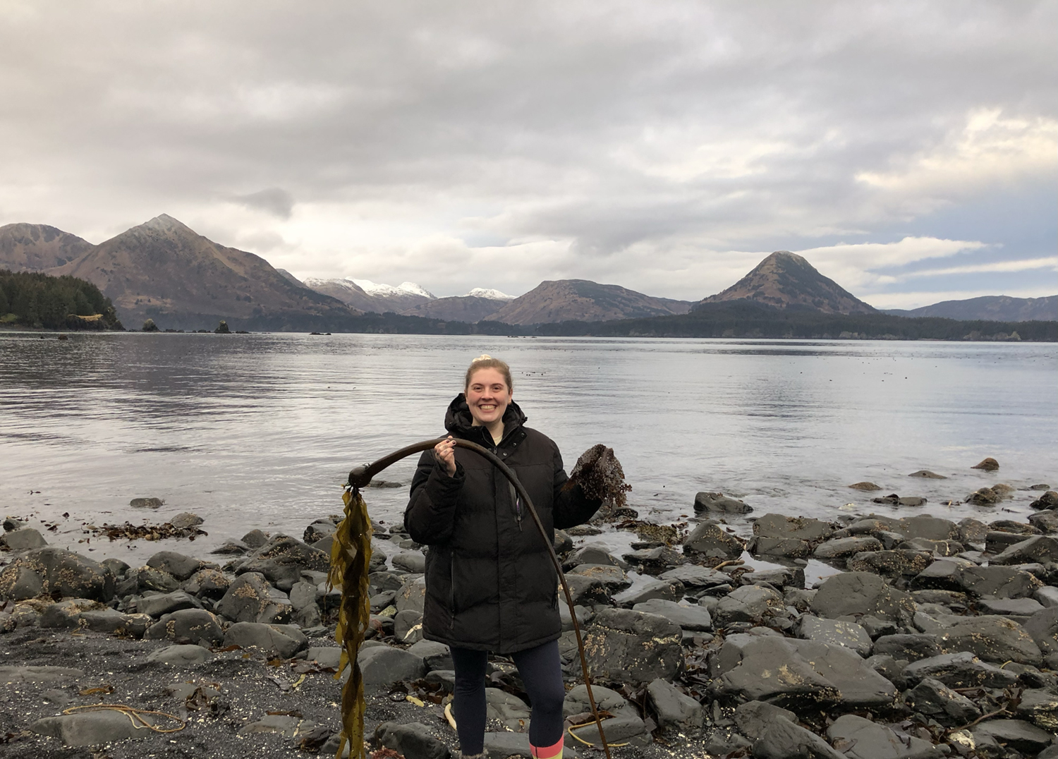 Tori McDermott holding bull kelp. Photo courtesy of Tori McDermott.