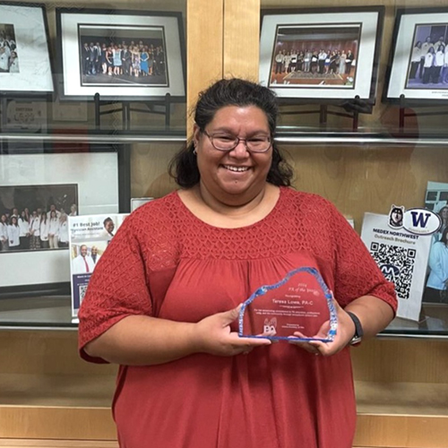 Teresa Lowe holding her 2024 AKAPA PA of the Year Award in the MEDEX Anchorage office. Photo by MEDEX Northwest