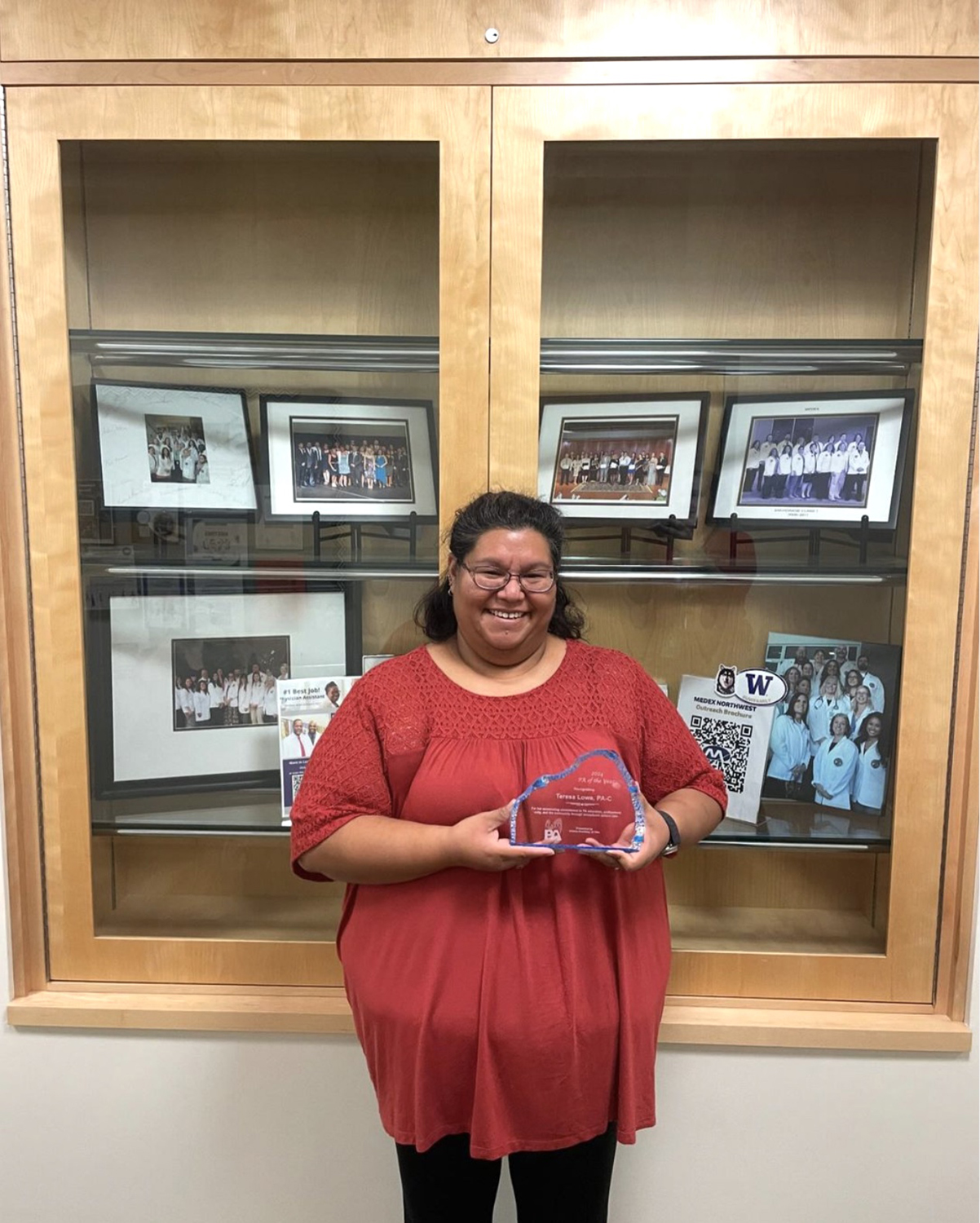 Teresa Lowe holding her 2024 AKAPA PA of the Year Award in the MEDEX Anchorage office. Photo by MEDEX Northwest