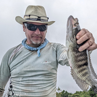 Igor Pasternak holding a fish. Photo courtesy of the UAF Art Department