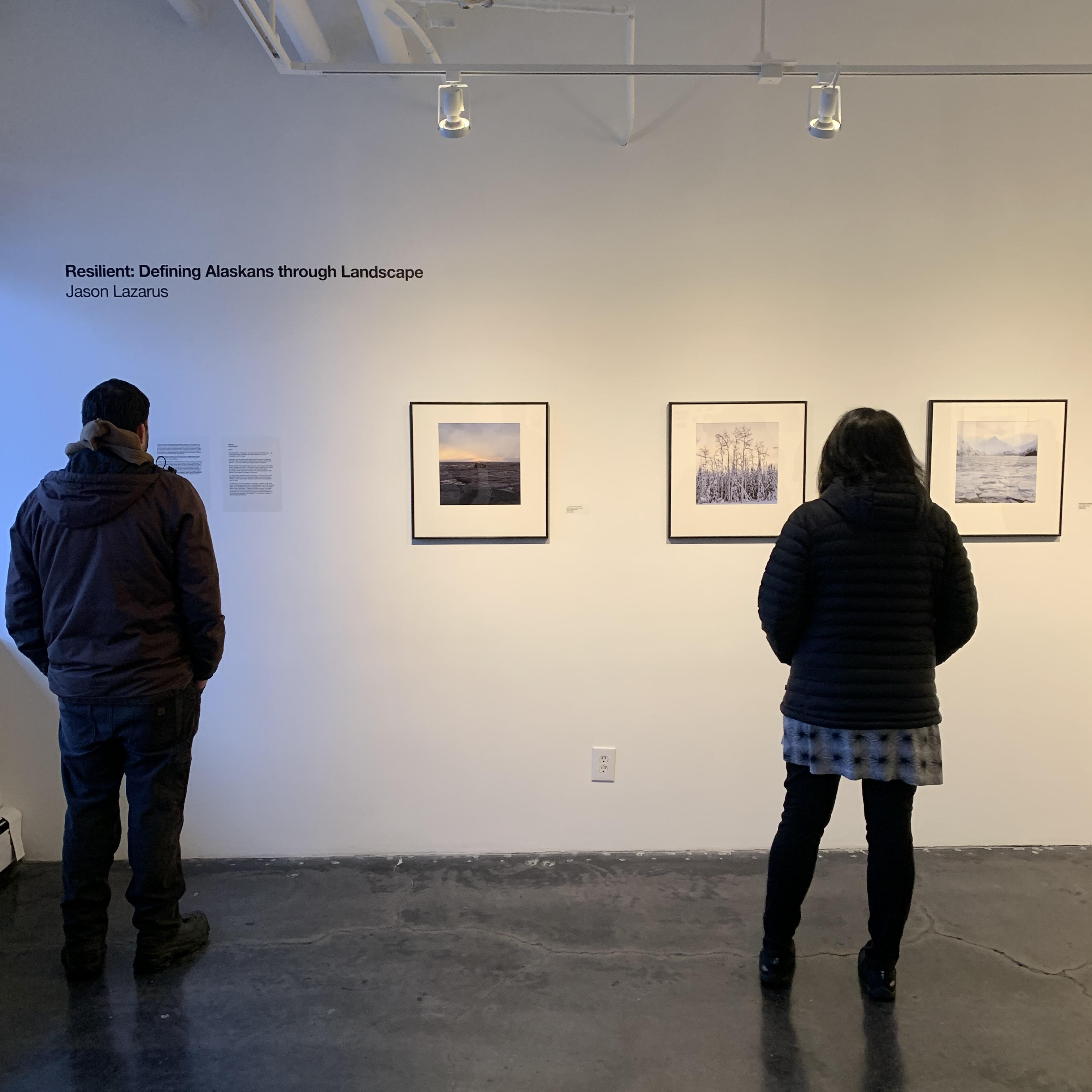 Two attendees viewing Lazarus' work at the International Gallery of Contemporary Art in Anchorage. Photo courtesy of Lazarus.