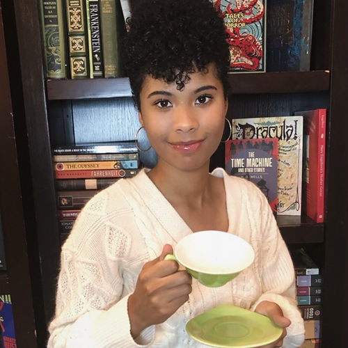 2024-2025 URSA Student Belonging and Community Award recipient Naomi King poses with a tea cup. Photo courtesy of King.