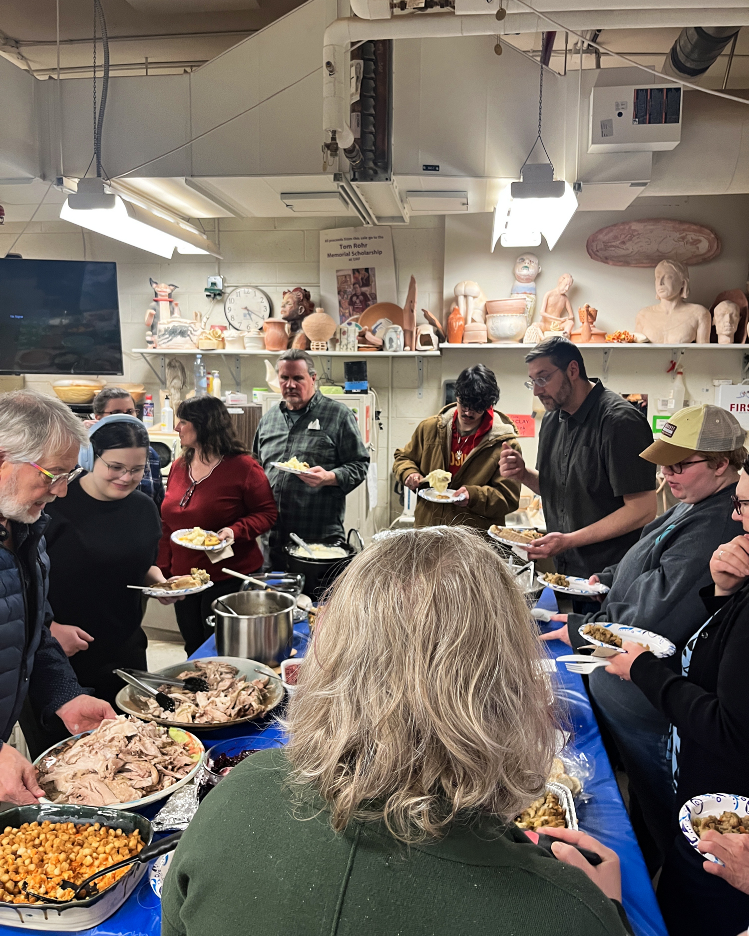 Attendees fill their plates at the annual SCAG Thanksgiving potluck held in the UAF Ceramics Studio. UAF Photo by Abby Druckenmiller