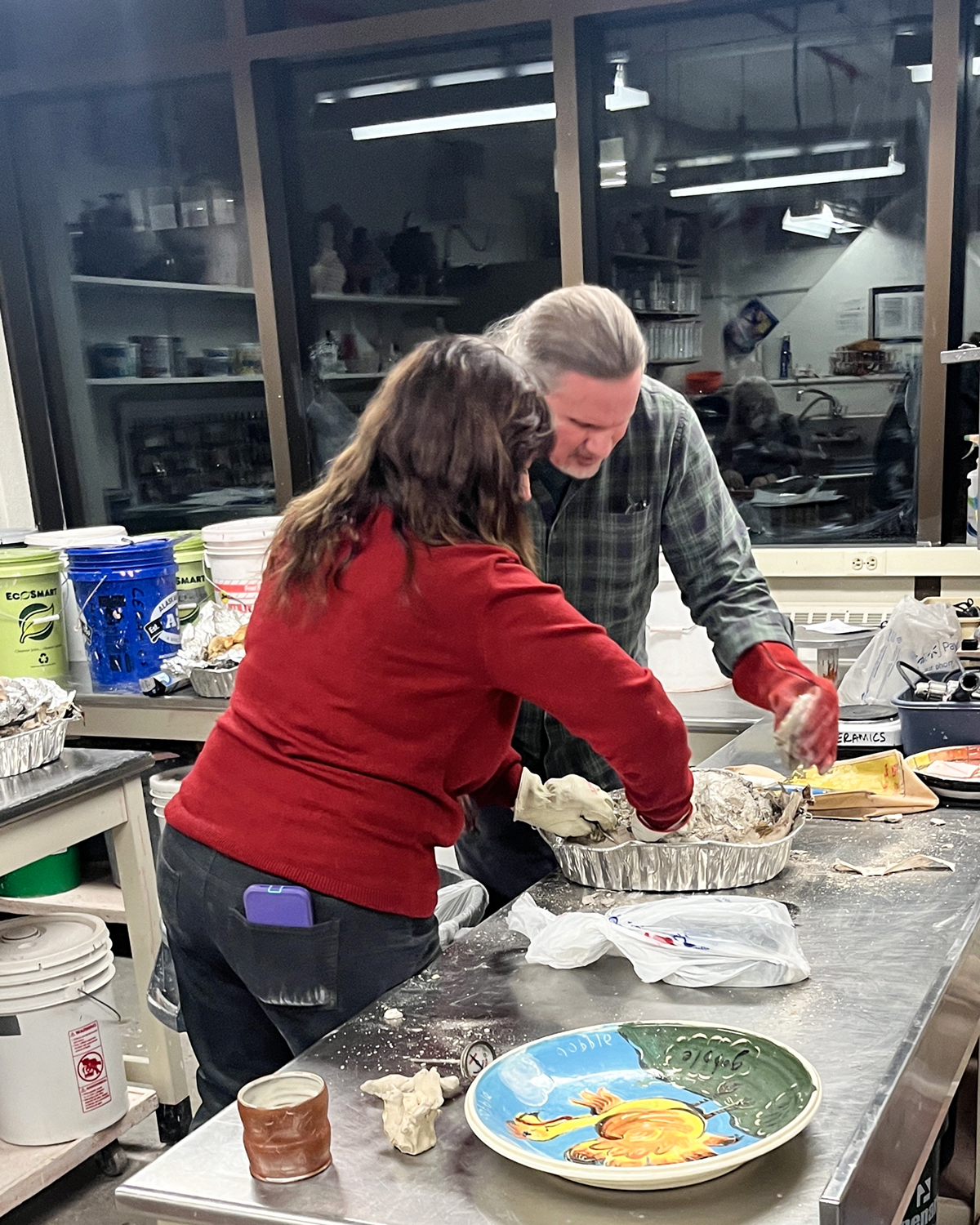 Olena and Rex Ellis prepare a turkey to go in the kiln at the annual SCAG Thanksgiving potluck held in the UAF Ceramics Studio. UAF Photo by Abby Druckenmiller