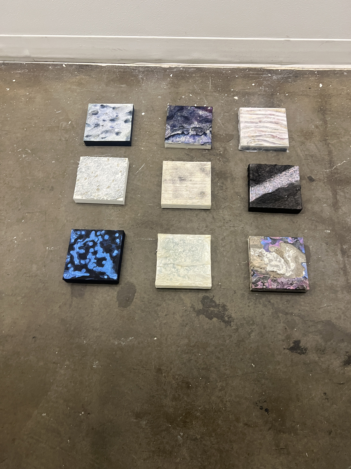 A grid of nine square paintings ready to be hung in the UAF Art Gallery. Photos courtesy of Bitzer & Dixon