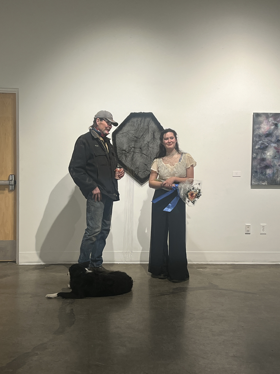 Ayona-Reily Dixon posing in front of a piece of artwork in the UAF Art Gallery. Photos courtesy of Bitzer & Dixon.