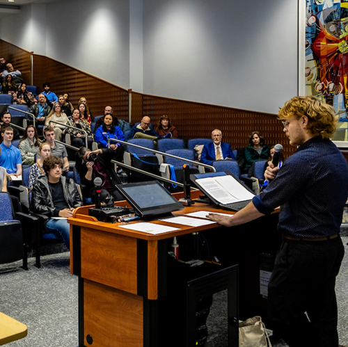 UAF Scholar Eli Knapp gives a speech at the UA Scholars Recognition Ceremony hosted in Schaible Auditorium, 11/2/23. (UAF photo by Leif Van Cise)