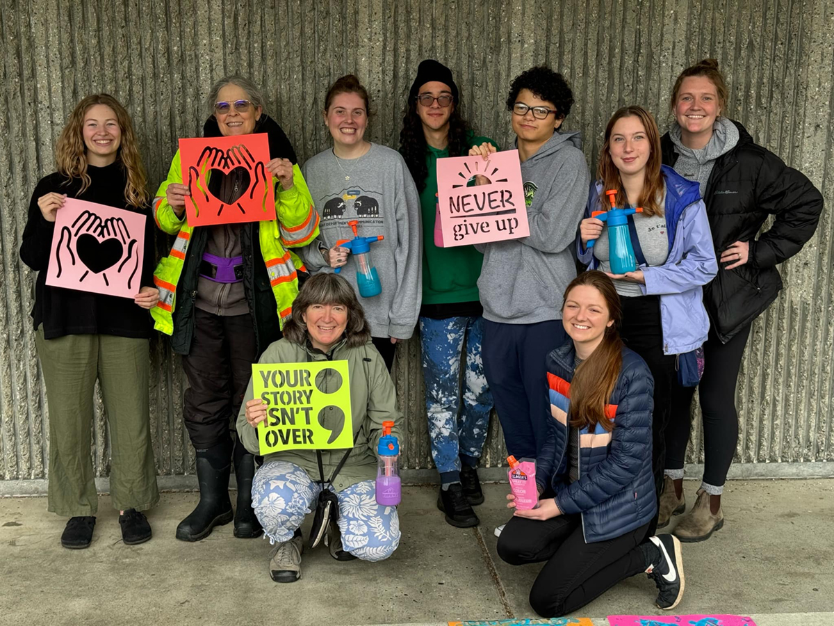 Students and faculty from the Women, Gender and Sexuality Studies program pose for a group photo during their Chalk the Walk event. UAF Photo 