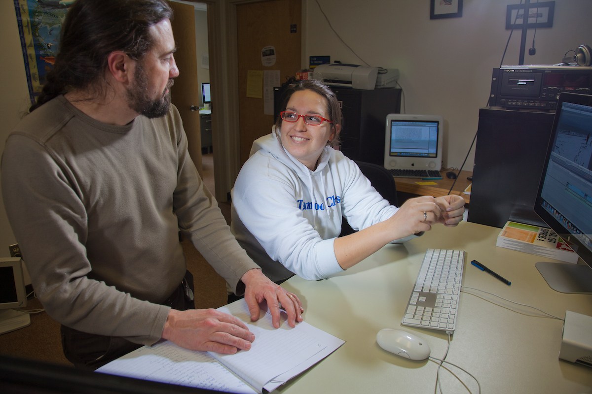 Assistant professor Mark Sicoli works with graduate student Allison Little on her cultural anthropology project in an Eielson Building media lab. UAF Photo by Todd Paris