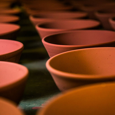 A series of red ceramic bowls fired in one of the art department kilns