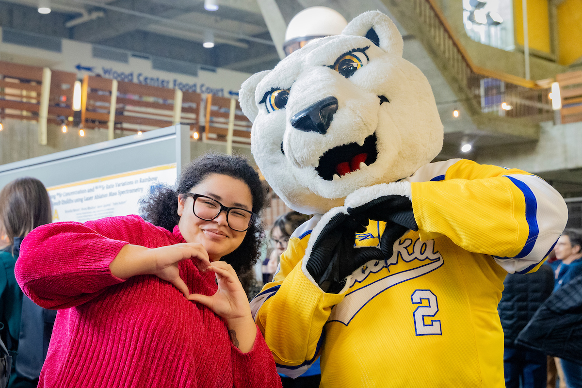 Japanese language student Paradise Porter poses with Nook on RCA Day 2024. UAF Photo by Leif Van Cise