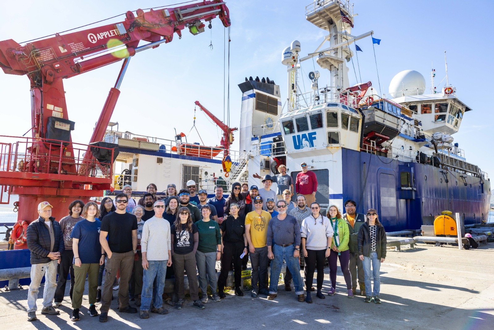 crew standing in front of r/v Sikuliaq (boat)
