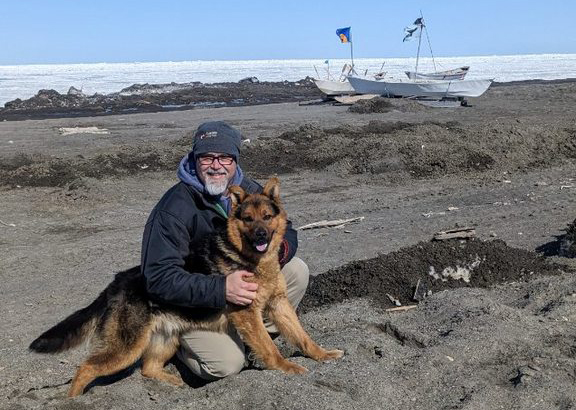man with dog at beach