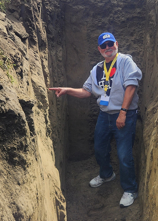 Rod Moore points at an interesting spot in one of the soil pits on the Fairbanks Experiment Farm on July 17, 2026.