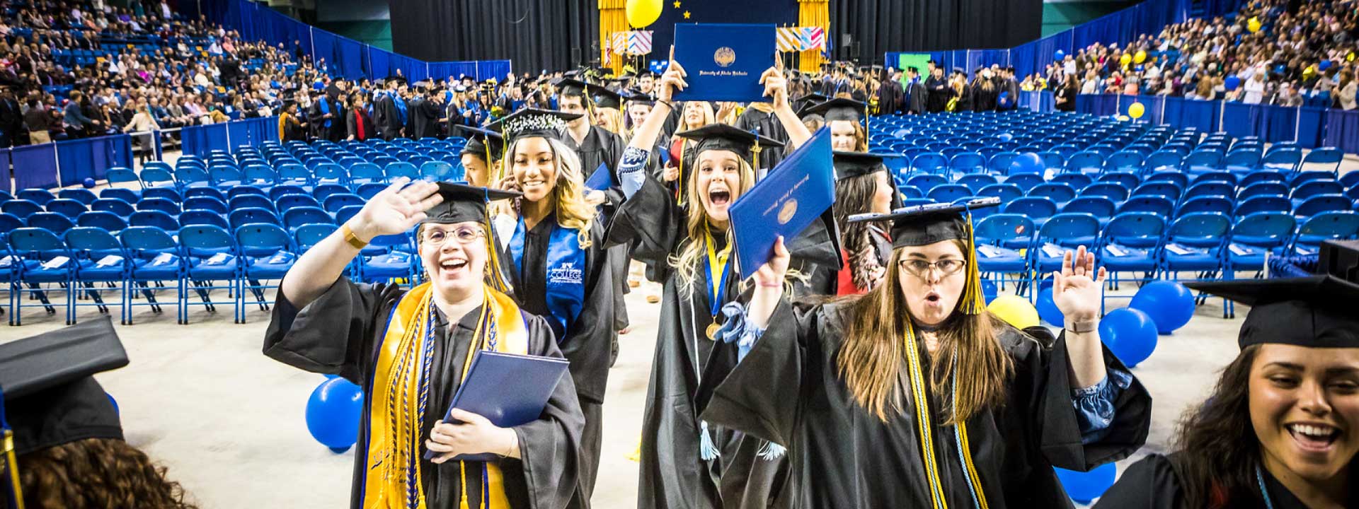 Celebrating students proceed out of the Carlson Center after the 2018 commencement ceremony