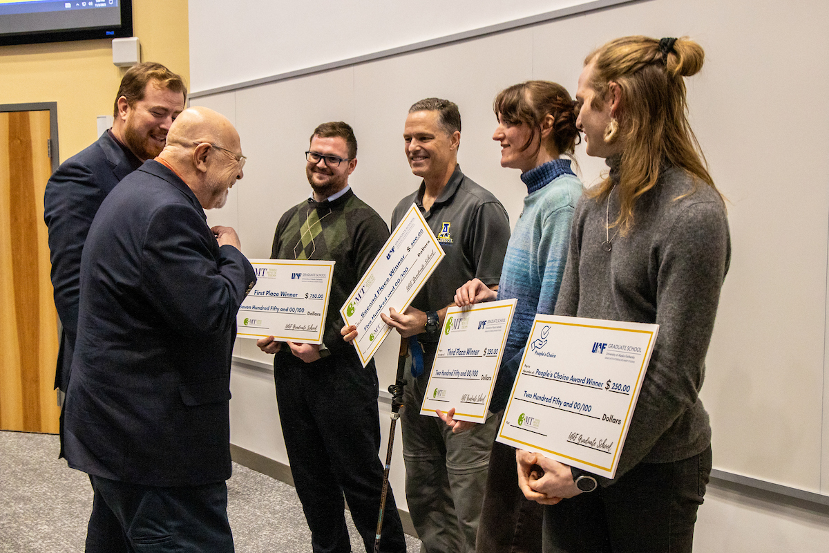 Winning graduate students interact with members of the judging panel during the annual 3-Minute Thesis event on Friday, November 3, 2023 in the Schaible Auditorium. UAF Photo by Marina Santos